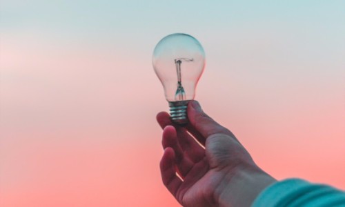 Entrepreneur with an Idea Aolding a Light Bulb