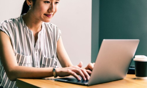 UpdatingResume Woman sitting at a computer updating her resume for a career change